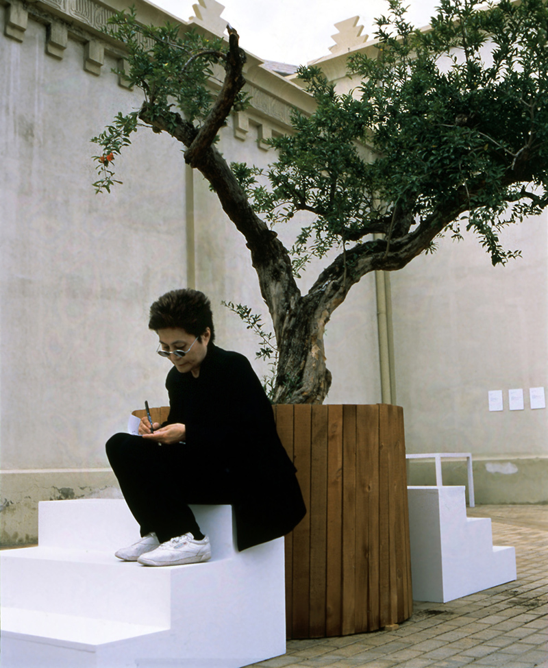 Yoko Ono, <i>Wish Tree</i>, 1996/1997, Installation view with artist seated, En Trance – Ex It, Lonja del Pescado, Alicante, Spain (June 23 – July 25, 1997), Photo: Miguel Angel Valero, Courtesy of Yoko Ono